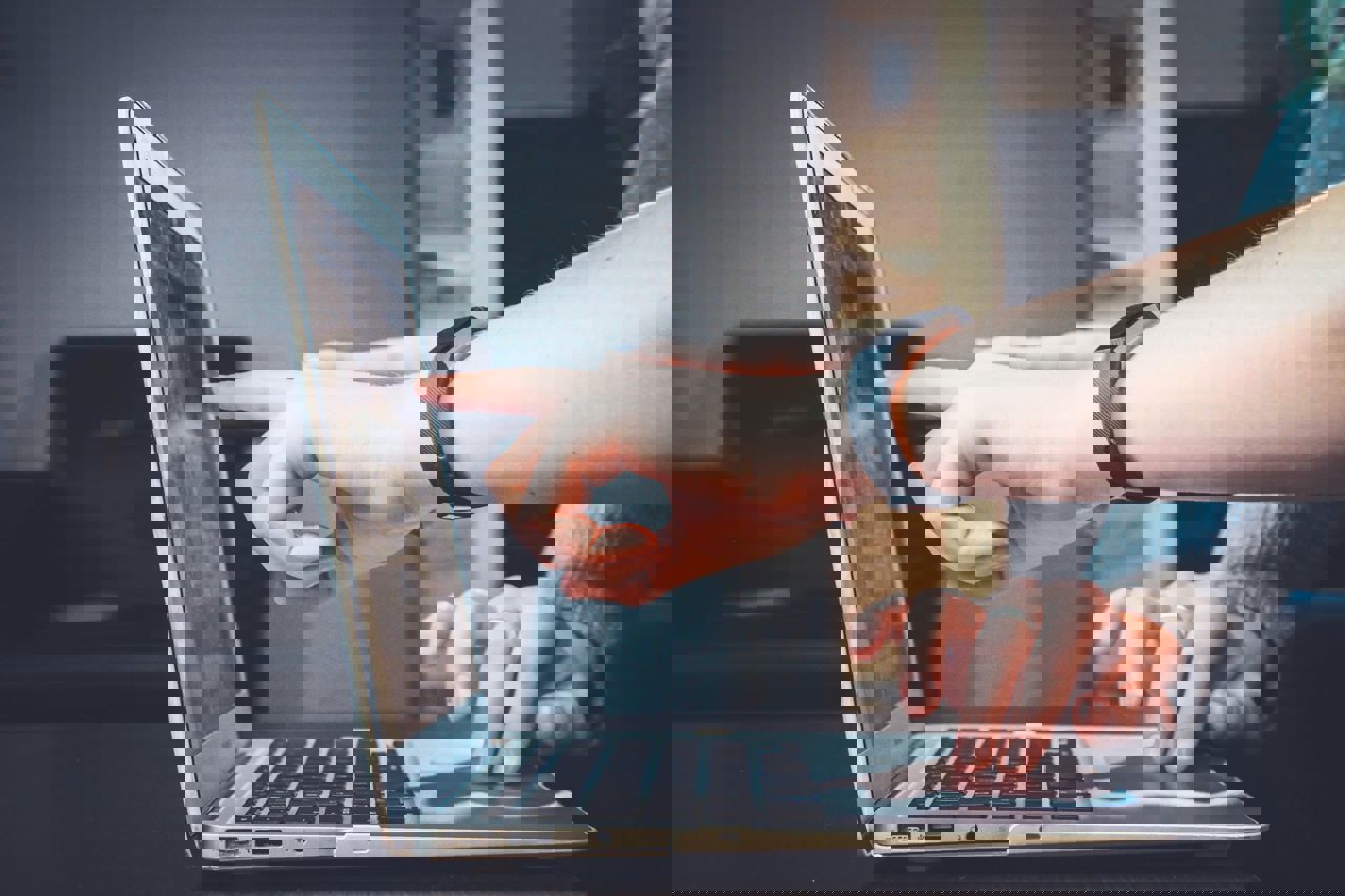 finger pointing at computer screen