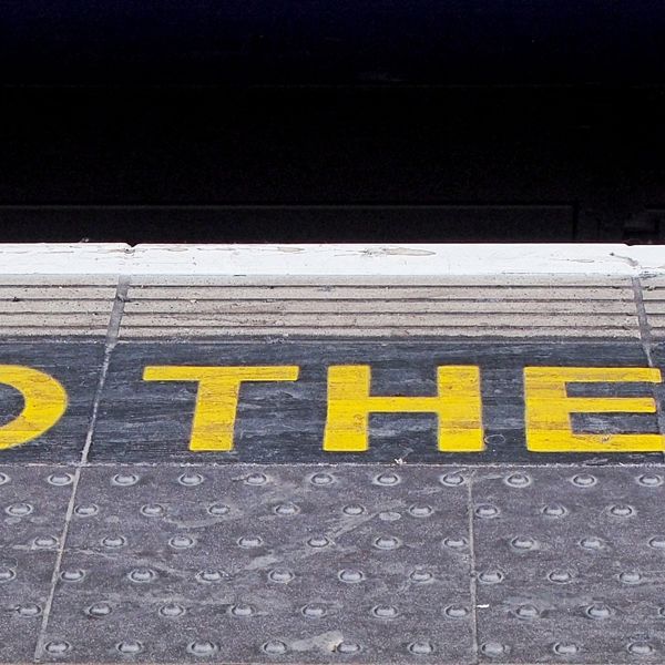Mind the gap sign at underground train station.