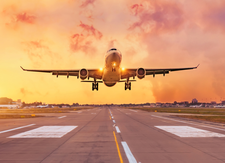 airplane taking off in sunrise