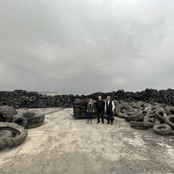 Members of the Nanografen team at a waste tyre disposal site.
